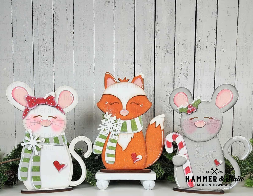 Forest Friends Christmas shelf sitter of a fox, mouse, and cat with festive accessories on a wooden background.