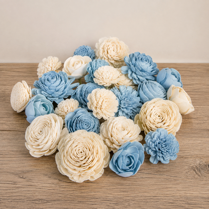 A pile of decorative wood flowers in light blue and cream colors used in a Book Vase Flower Arrangement