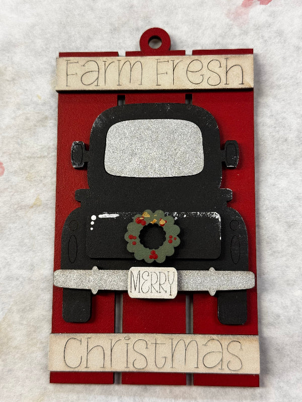 Decorative Christmas ornament with 'Farm Fresh Merry Christmas' text on a red background.
